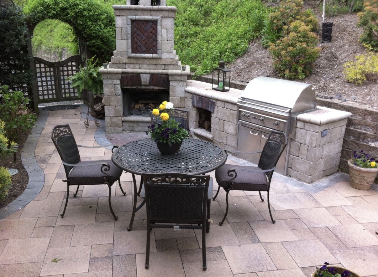 Paver patio with stone fireplace and built-in grill station